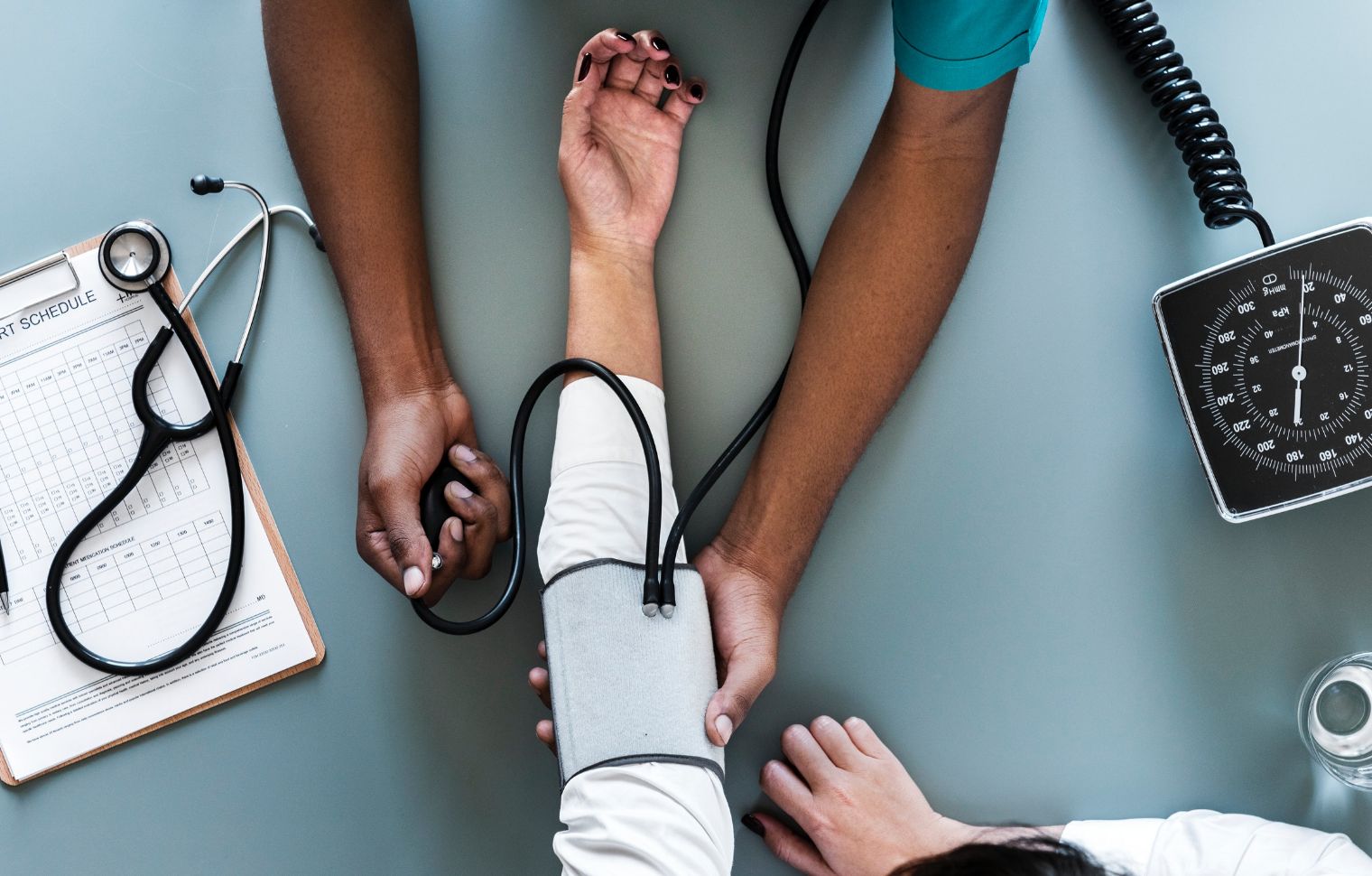Healthcare professional checking patients blood pressure